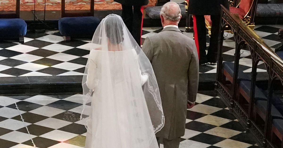 Photo of Prince Charles walking Meghan Markle down the aisle.