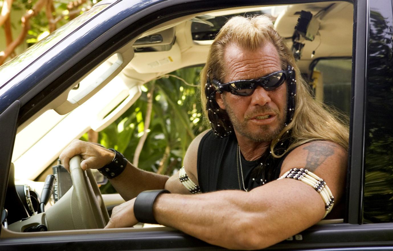 Dog the Bounty Hunter was back busting bad guys in a black muscle shirt that showed off his tattoo.