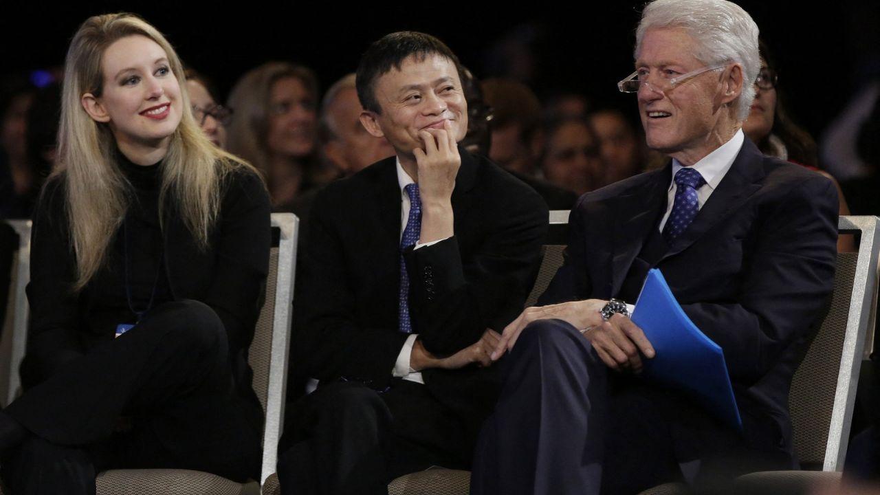 A photo of Elizabeth Holmes, Jack Ma, and President Bill Clinton