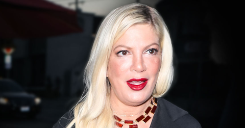 Tori Spelling Wearing Red Lipstick, Black Shirtdress With Brownish Red Necklace