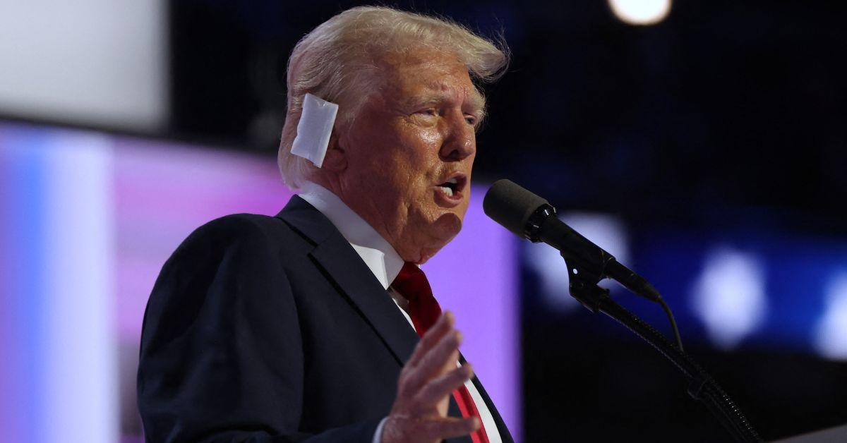 Donald Trump gives a speech with a white bandage on his ear 