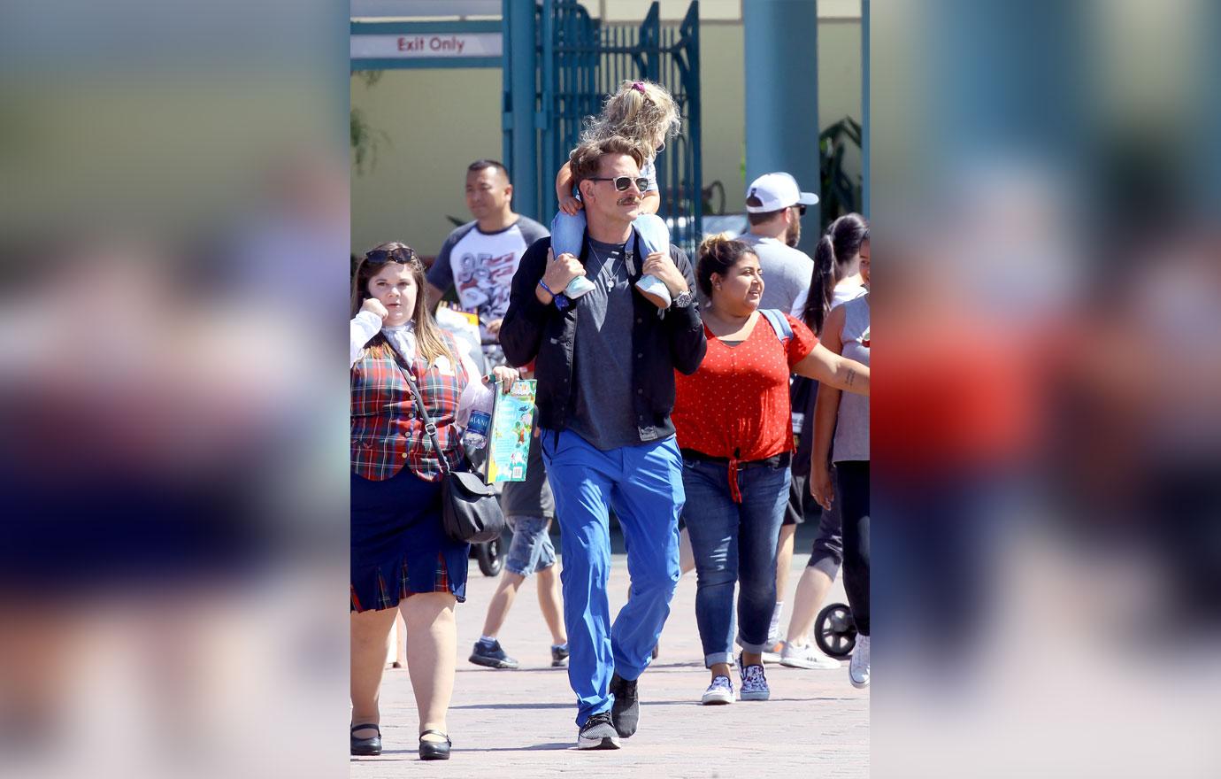 Bradley Cooper enjoys a day at Disneyland with his daughter Lea.