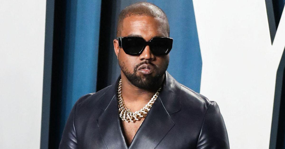 Kanye West leaving his office in a red and blue checkered jacket