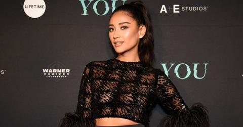 Shay Mitchell Wearing Sheer Black Sequin Feather Trimmed Top and Black Silk Satin Skirt With Peplum Rufffle