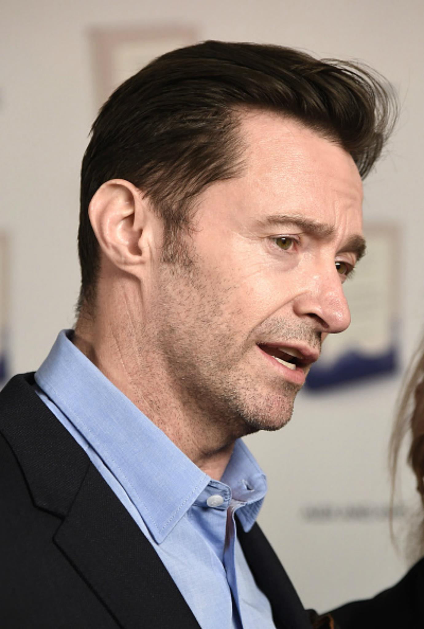 Hugh Jackman talks on the red carpet.