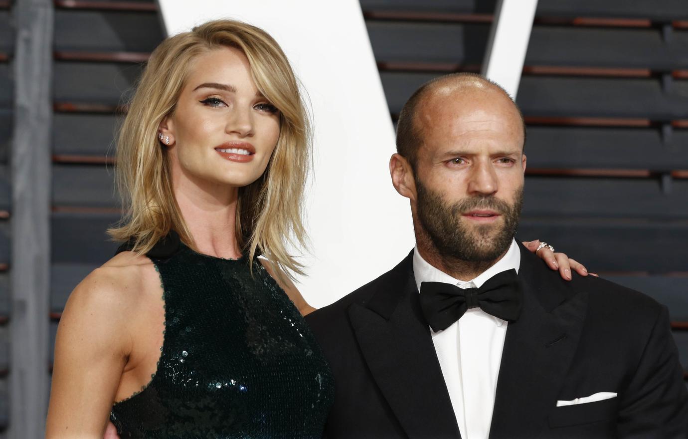 Rosie Huntington-Whiteley in a black dress and Jason Statham in a tux