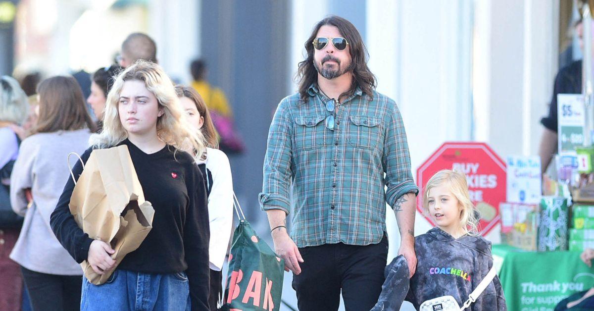 Grohl holding daughter Ophelia's hand. 