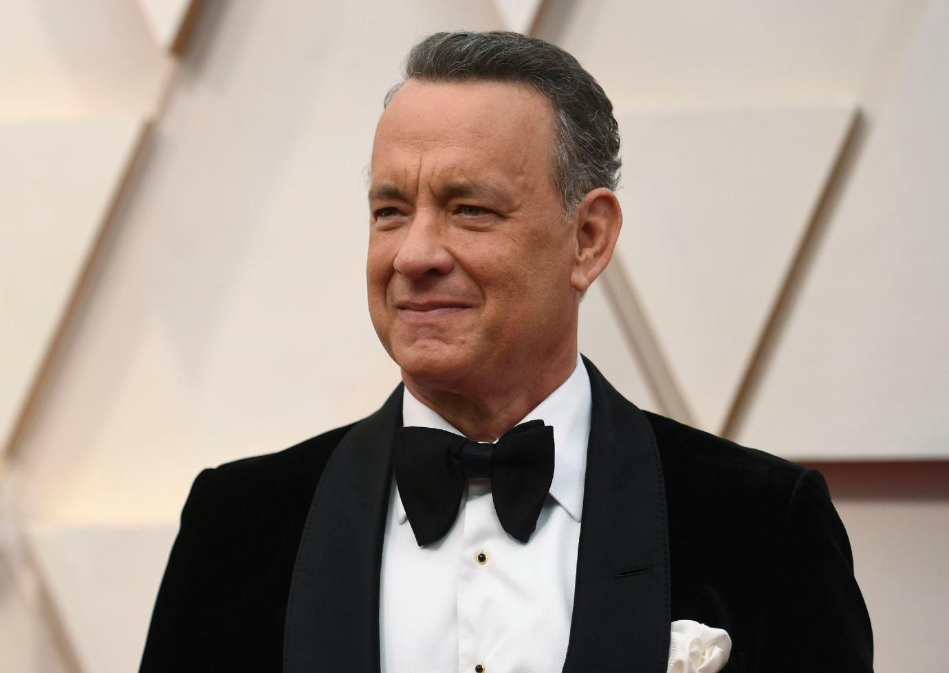 Tom Hanks smiles in a black tuxedo at the 2020 Golden Globes