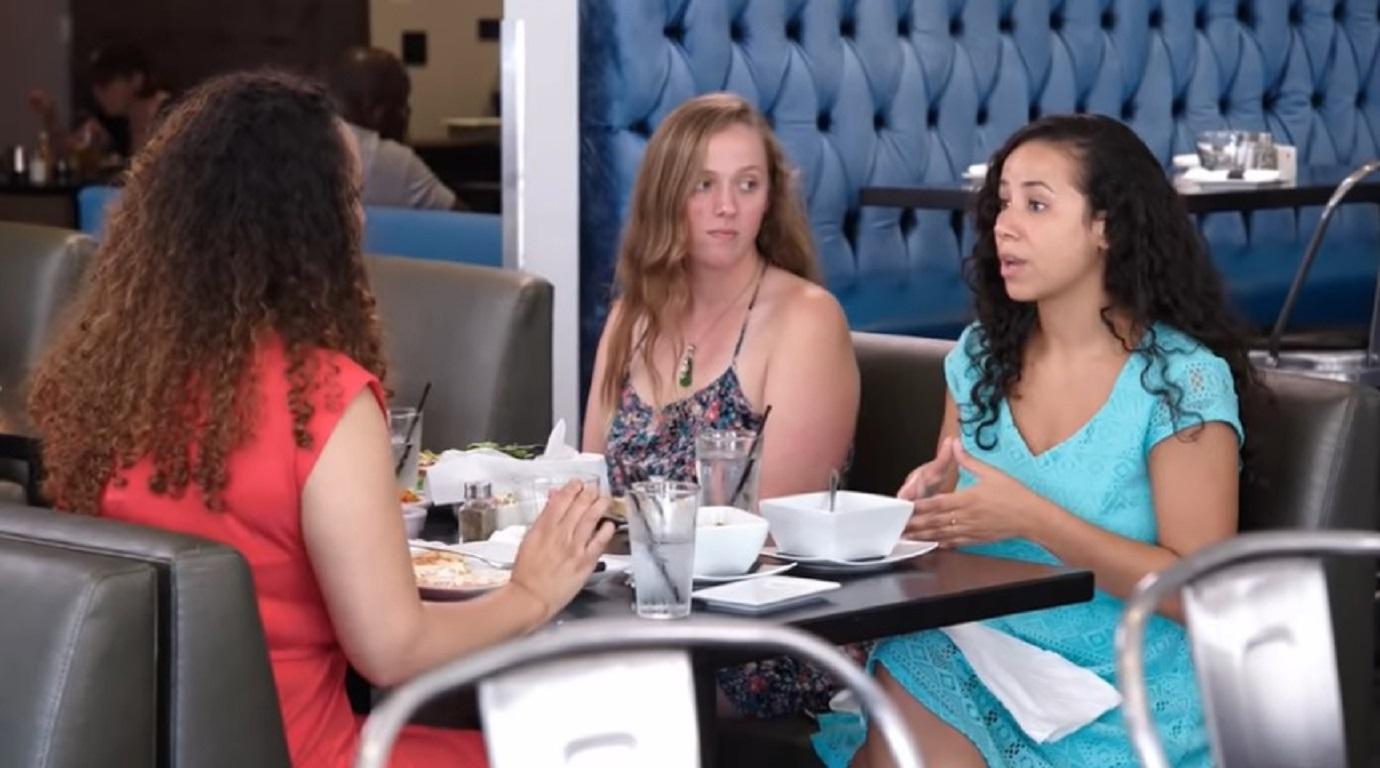 Vanessa Cobb and her sisters talk while eating lunch in a restaurant.