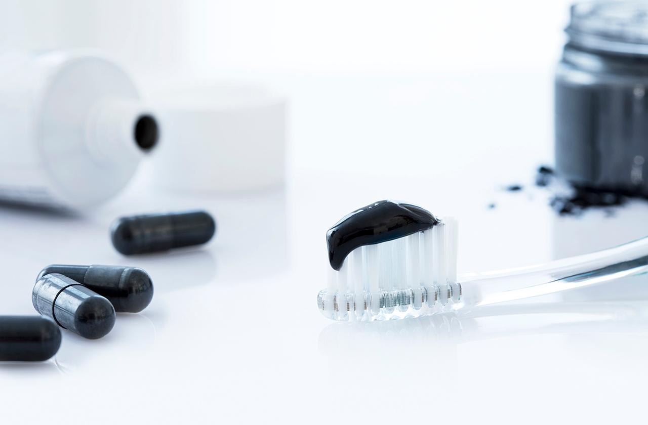 Charcoal toothpaste on a toothbrush.