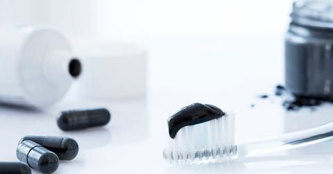 Charcoal toothpaste on a toothbrush.