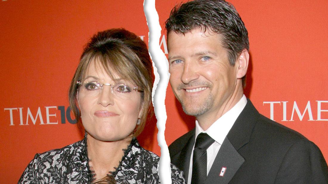 Ripped Down The Middle Photo Of Sarah Palin Wearing Black and White Lace Dress Standing Next To Husband Todd Palin Wearing Dark Gray Sui