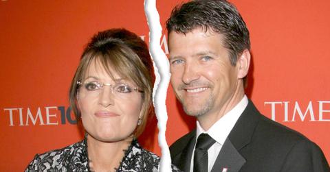 Ripped Down The Middle Photo Of Sarah Palin Wearing Black and White Lace Dress Standing Next To Husband Todd Palin Wearing Dark Gray Sui