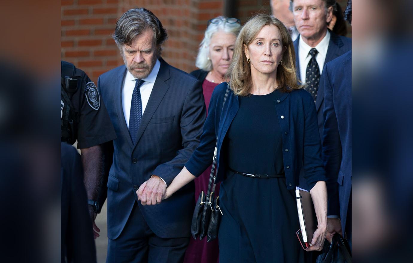 Felicity Huffman (R) and her husband actor William H Macy (L) exit the John Joseph Moakley Federal Courthouse following her sentencing in connection with the college admission scandal in Boston