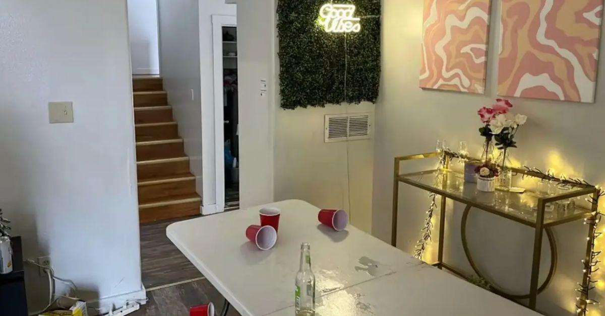 A folding table for beer pong, red Solo cups and an empty beer bottle were seen in a living space.