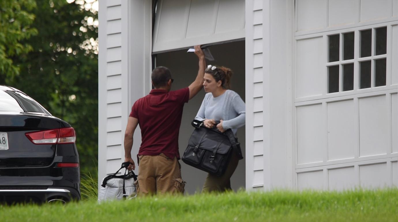 Fotis Dulos with a mystery woman in front of the garage.