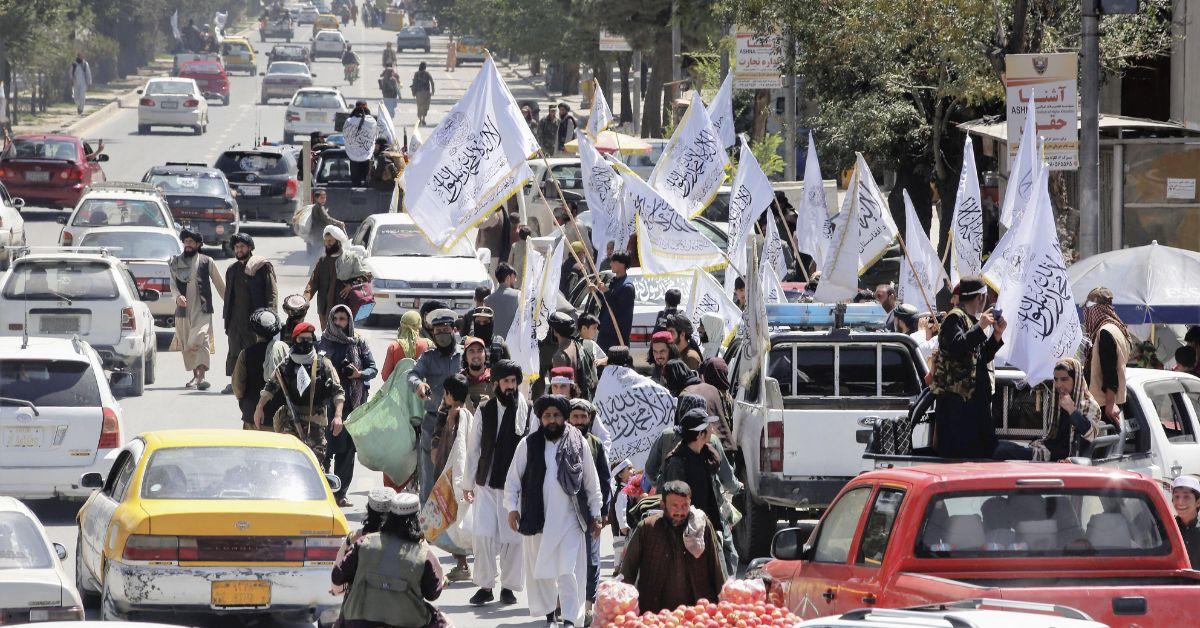 Afghanistan People Walking Through Street With Flags