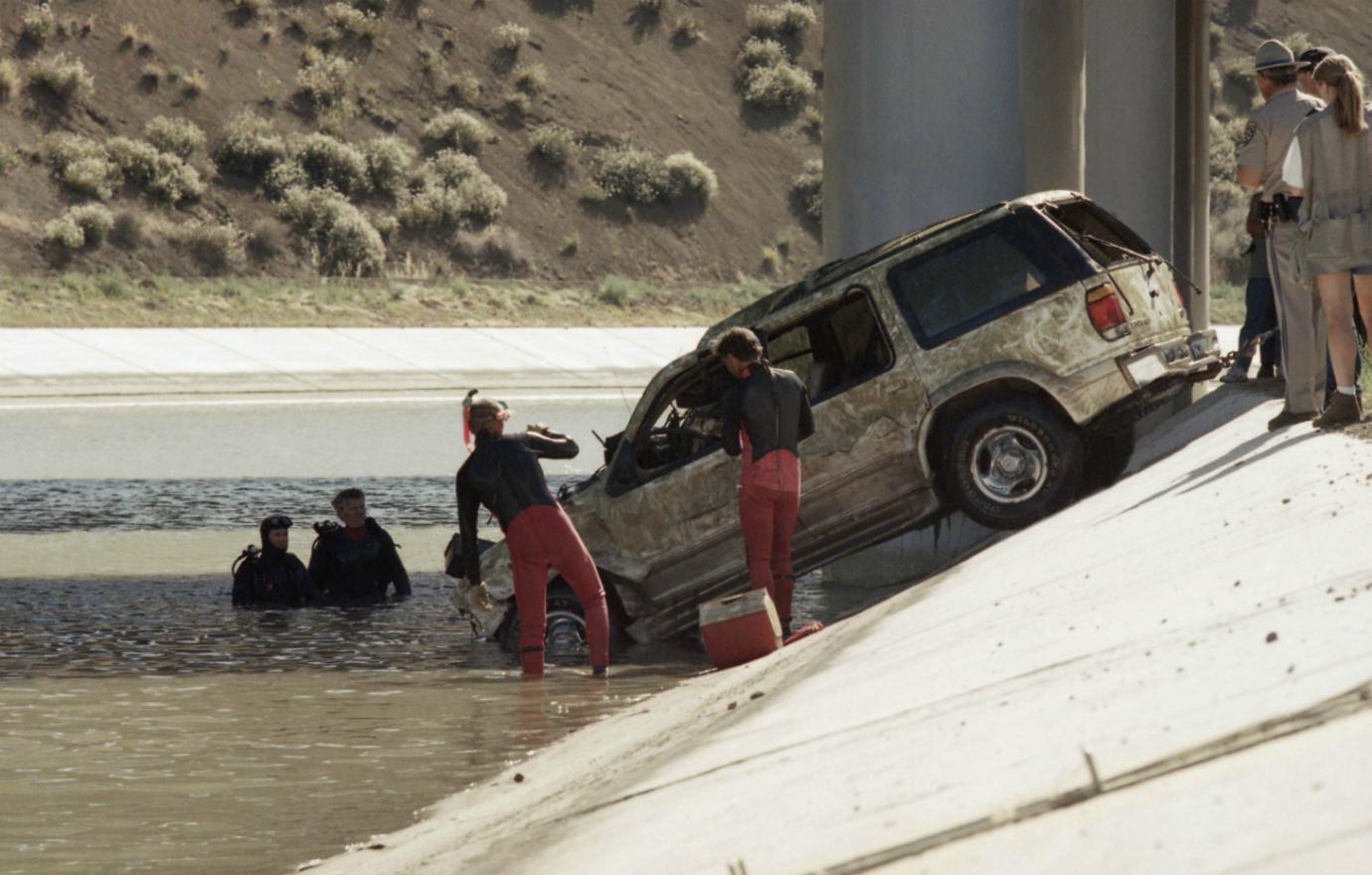 A car is dredged up from the water.