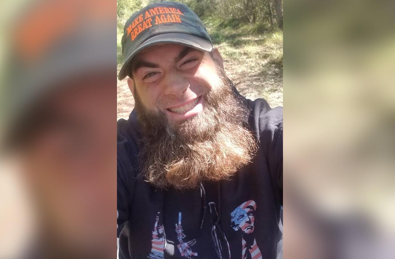 David Eason takes a selfie while wearing a MAGA hat.