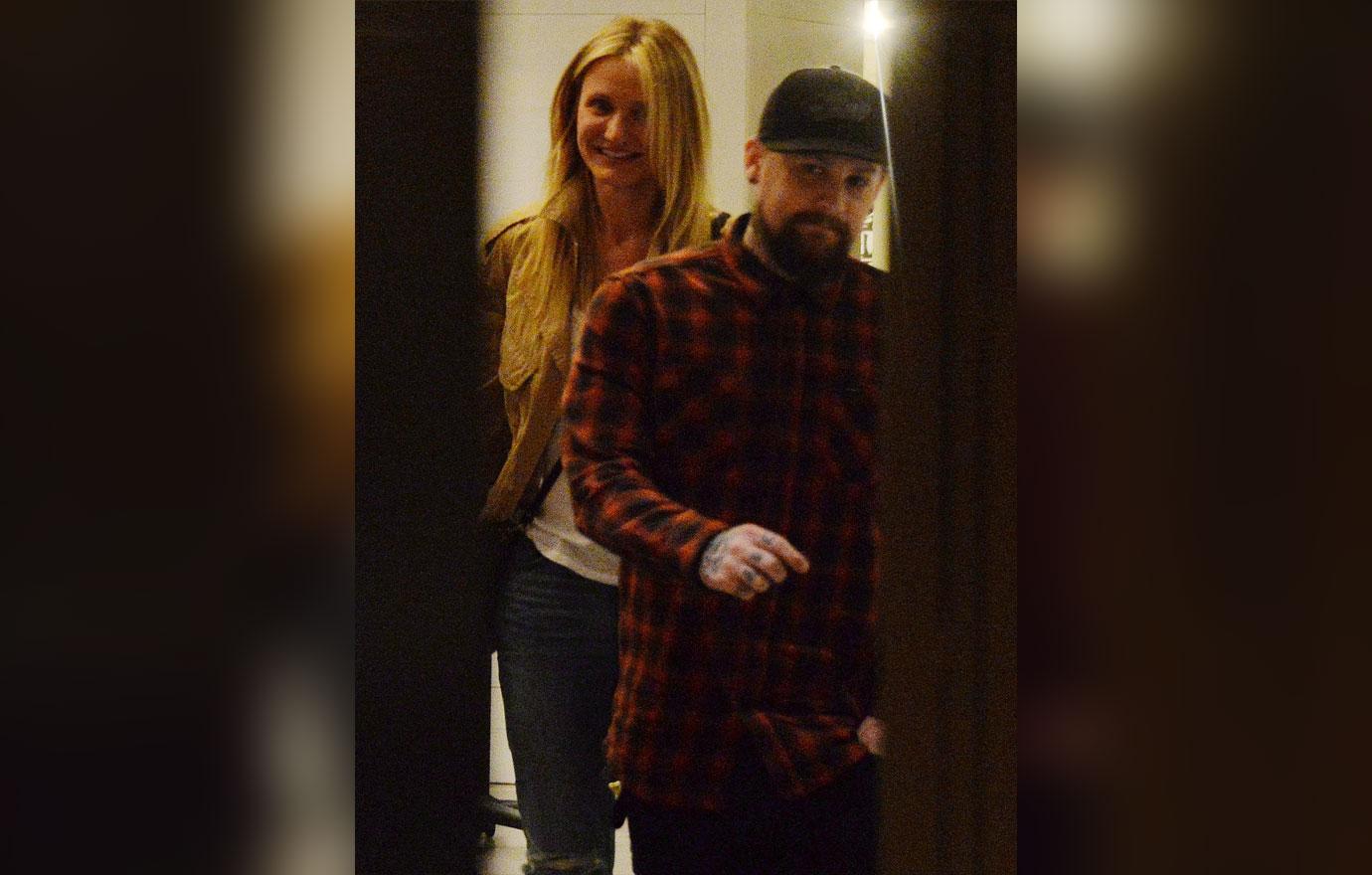 Benji Madden wears a plaid shirt, while Cameron Diaz wears a beige jacket and jeans.