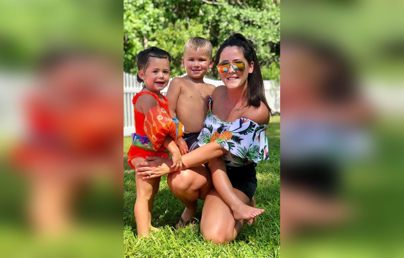 Jenelle Evens in Tropical Off The Shoulder Ruffle and Black Shorts WKneeling With Her Kids in Swimsuits