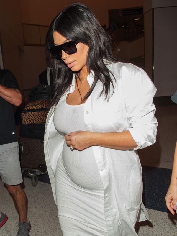 Kim Kardashian Flaunts Baby Bump In White Dress