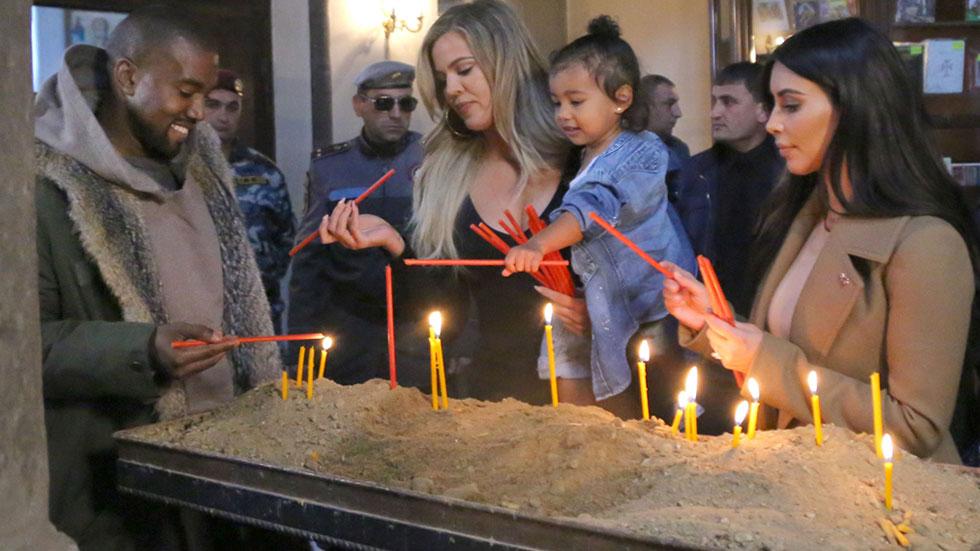 Kim & Khloe Kardashian Light A Candle In Armenia With North West