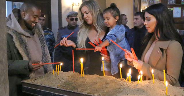 Kim & Khloe Kardashian Light A Candle In Armenia With North West