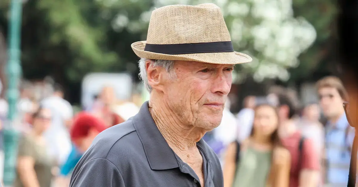 Photo of Clint Eastwood in cream hat with black stripe.