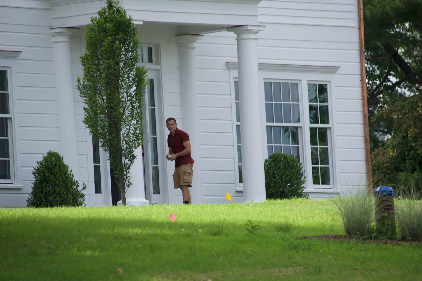 Fotis Dulos standing in front of the house