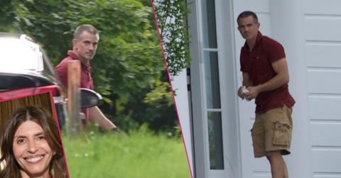 Fotis Dulos standing in front of the house