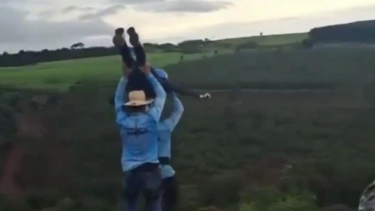 Video of the incident shows workers hoisting the woman over their heads and tossing her 'airplane style'.