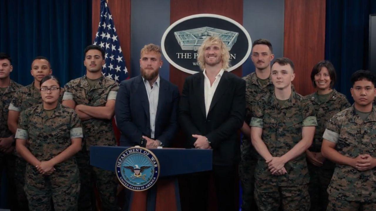 A photo of Jake and Logan Paul with servicemen and women