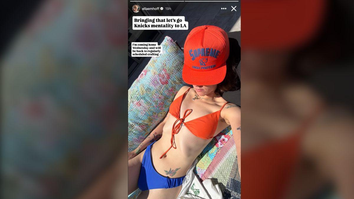 image of She paired her tiny string bikini with a bold orange Supreme hat.