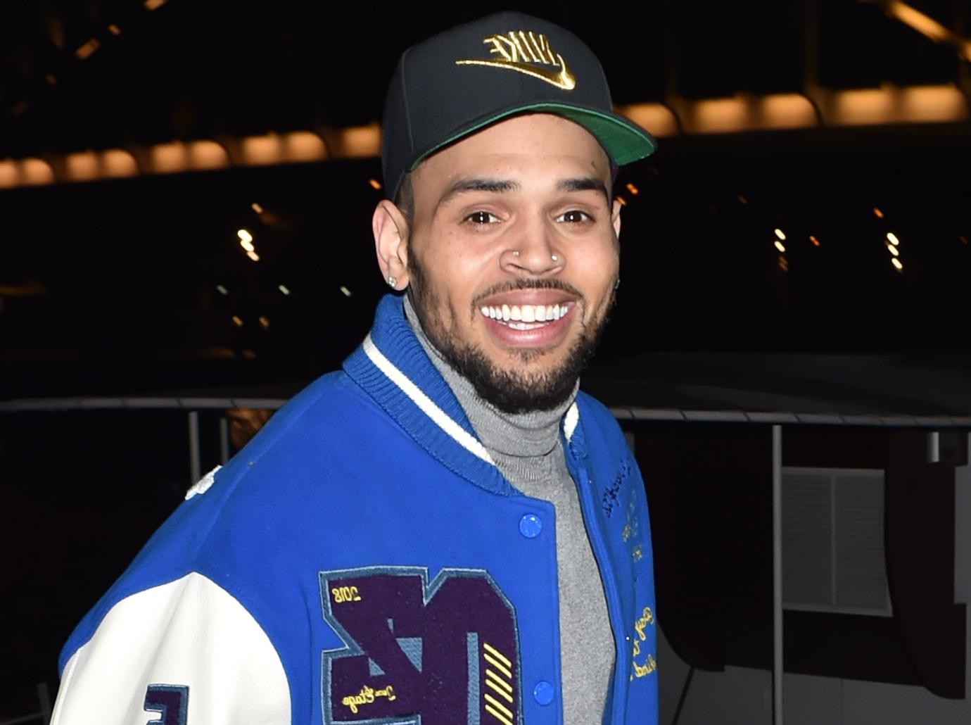 Chris Brown Flashes Peace Sign & Smirk Amid Battery Accusations