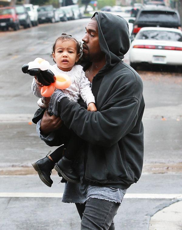 Kanye Kisses North West