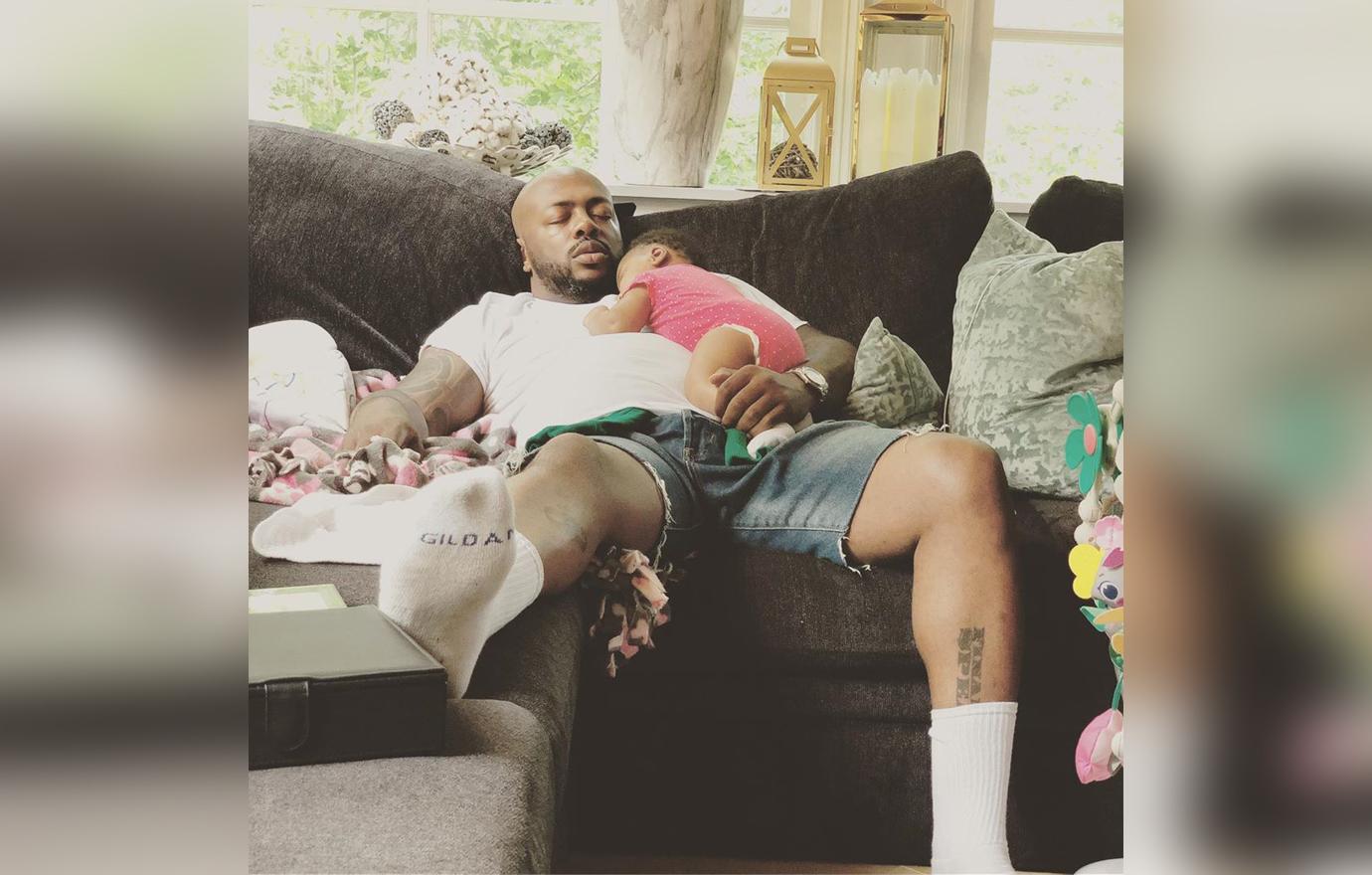 Dennis McKinley Naps On A Couch While He Holds Baby Pilar