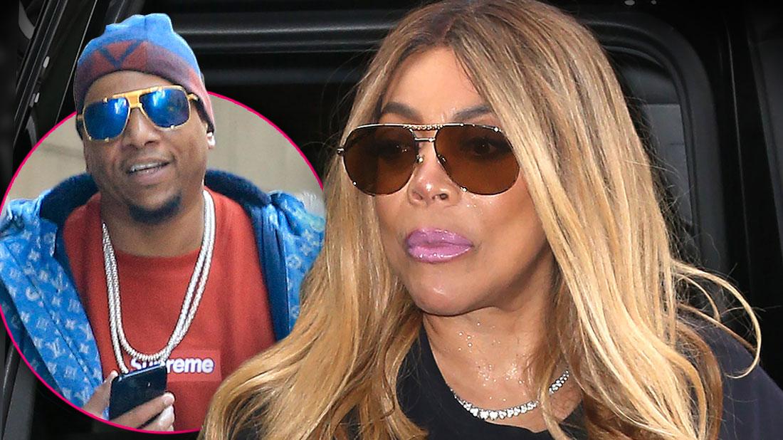 Inset Kevin Hunter Wearing Chains Around His Neck, Sunglasses, Blue And Red Hat, Red Supreme Shirt And Blue LV Parka, Wendy Williams Looking Sad Wearing Pink Lipstick, Sunglasses And Black T-Shirt